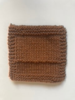 a knitted square swatch with garter border