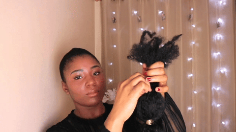 woman attaching bubble braids to bun