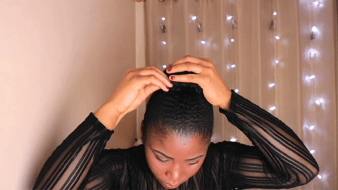 woman using bobby pins on bubble braids