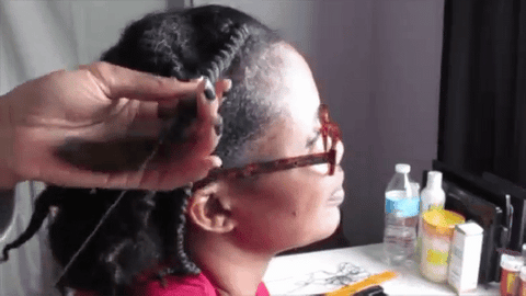 woman unraveling African threading