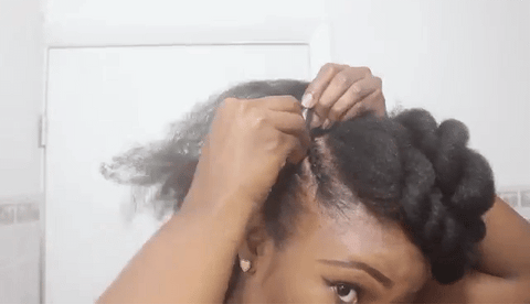 Lady braiding the side of her hair