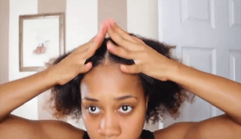 Lady applying gel to natural hair