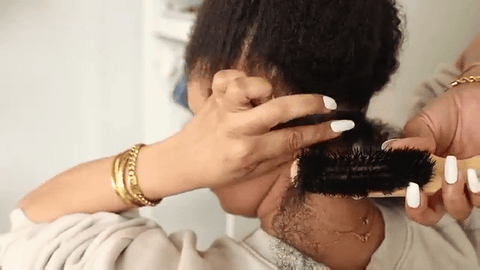 woman brushing natural hair
