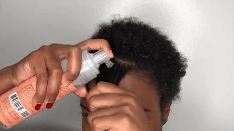 woman applying mousse to hair