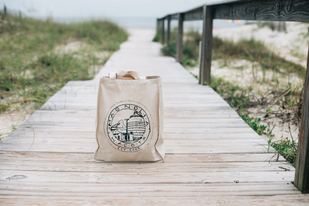 reusable canvas tote bag on beach boardwalk
