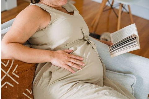 a pregnant woman reading a book