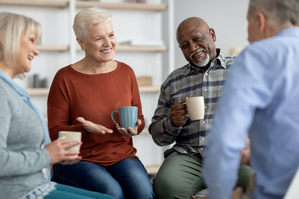 old-age-adults-sitting-upright-and-talking-with-coffee