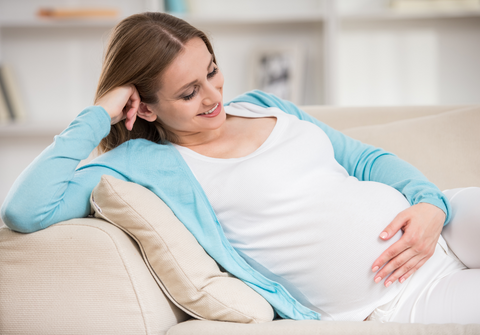 pregnant woman using a zero gravity recliner