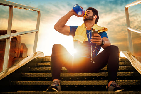 man drinking water post workout