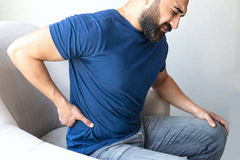 man seeking lower back pain treatment at home