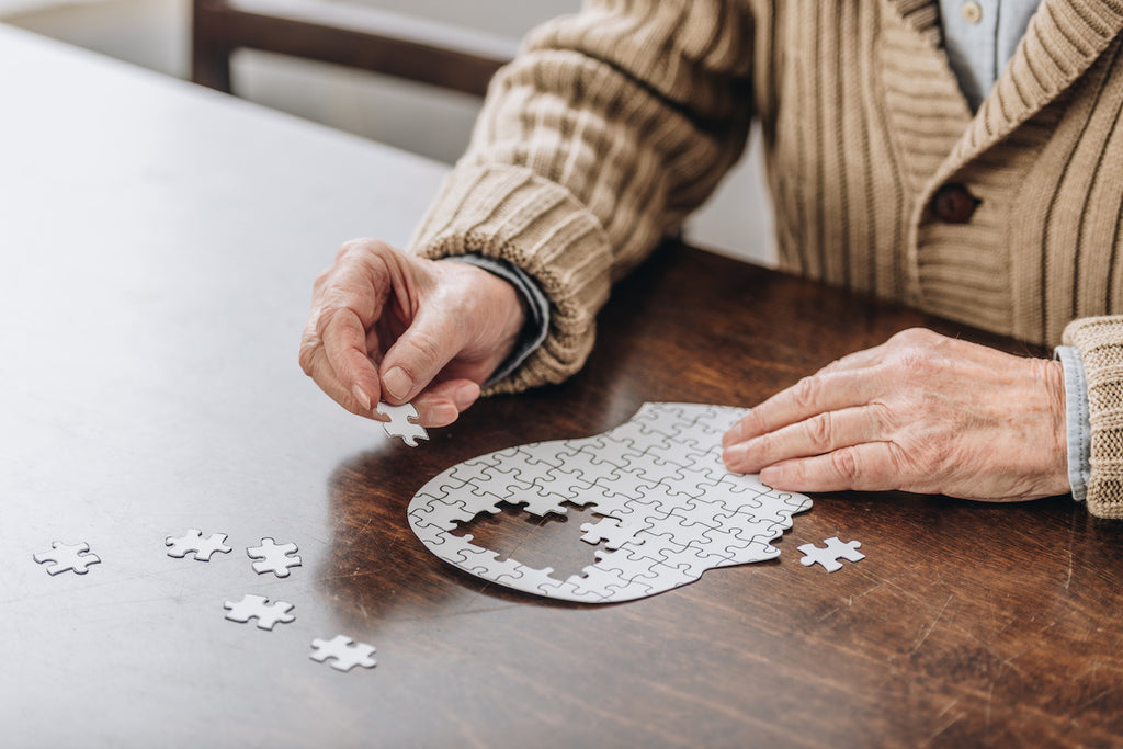 senior-doing-puzzle-at-table