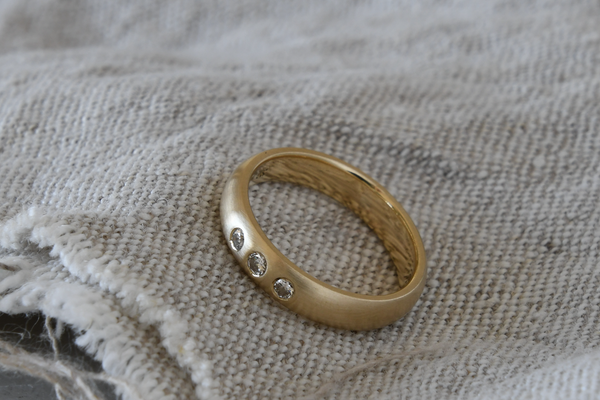Recycled gold wedding band with 3 heirloom ethical diamonds