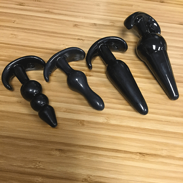 Training set of four black, flexible anal plugs.