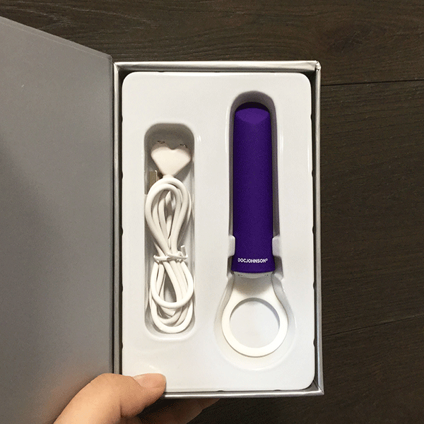 Purple Vibrator Shown In Original Packaging With White Charger