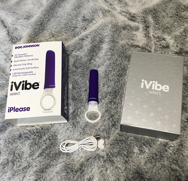 Mini Silicone Purple Vibrator On Bed With Boxed Packaging And Charging Chord