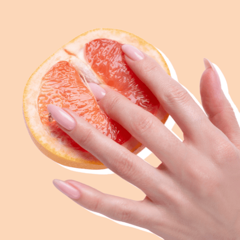 Image of woman fingering grapefruit that looks like a vagina