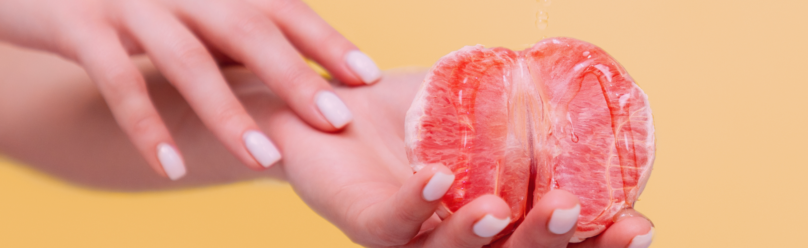 Grapefruit covered in lubricant in hand