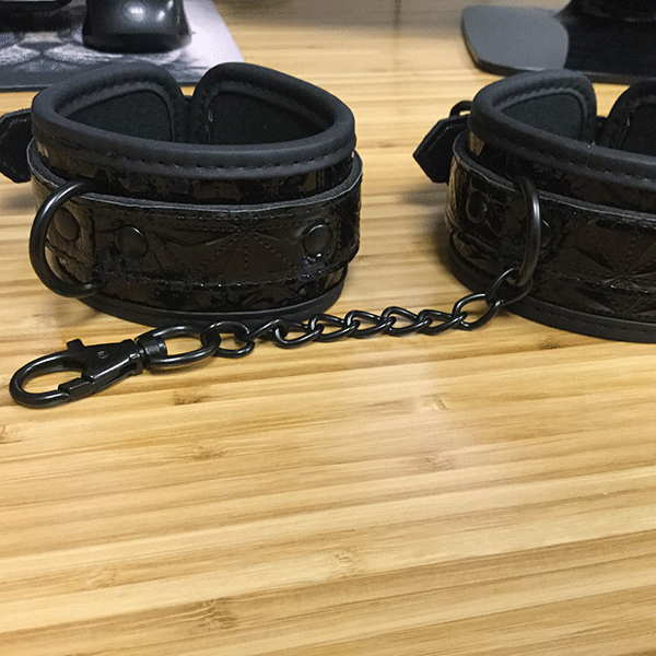 Cuffs Shown On Desk To See The Adjustable Straps And Chain