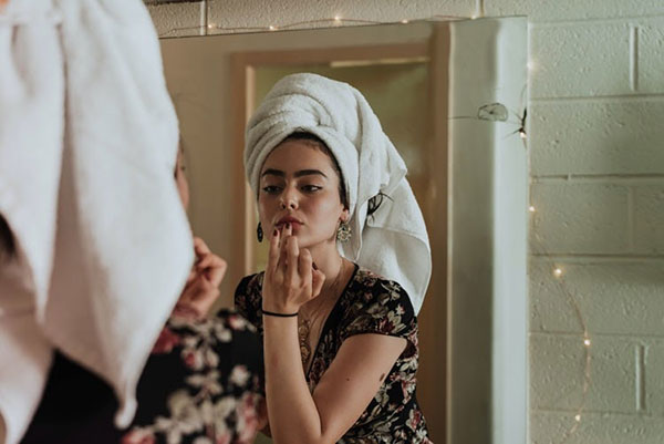 a woman primping in the mirror