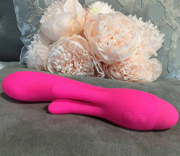 Hot Pink G Spot Vibrator Show On Bed Next To Bouquet Of Flowers