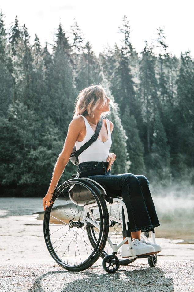 Woman in a wheelchair enjoying nature.