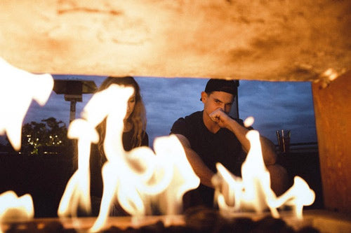 a couple in front of a fire