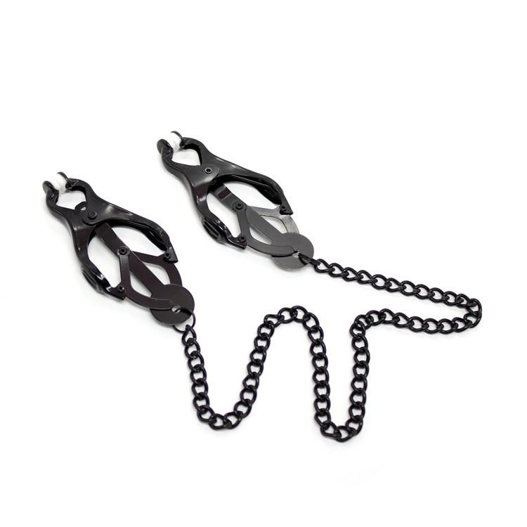 Image of set of black metal clover shaped clamps for nipples