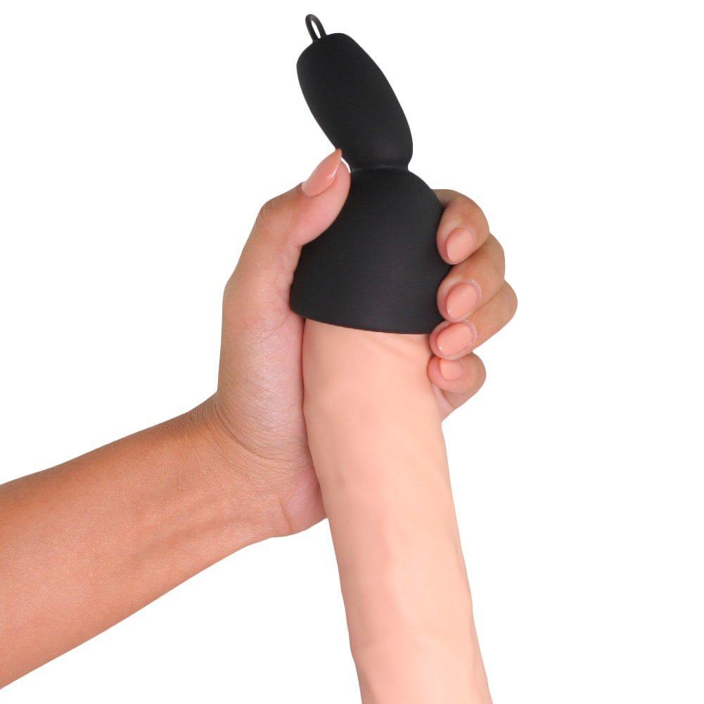 Image of the small black penis tip massager being used on a dildo