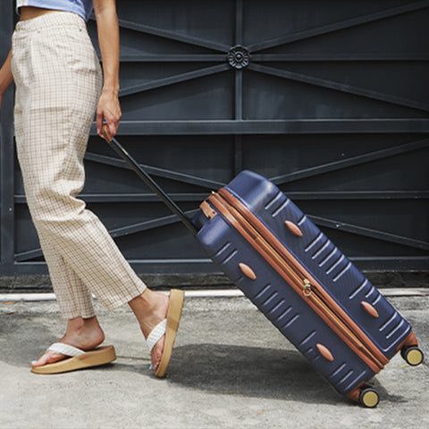 woman with navy luggage