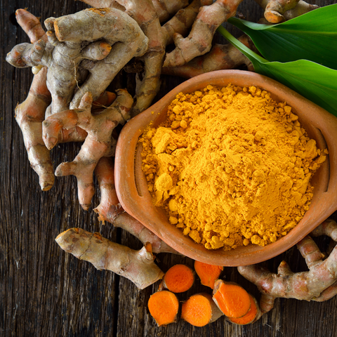 Whole Tumeric next to Tumeric Powder - Antioxi