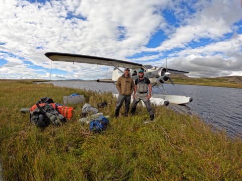 Drop off location for Steve and Sam. Standing next to the plane in the water with all of their gear scattered around them.