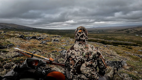 Sam in complete camo looking out over their landscape. 