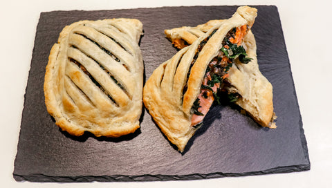 Salmon Wellington is a salmon fillet wrapped in spinach sauce and puff pastry.