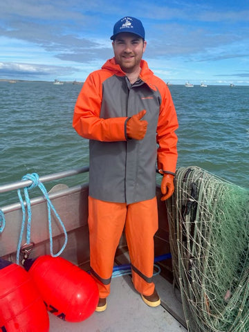 Taylor giving a thumbs-up on the deck of the boat