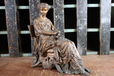 clock topper bronzed statue of seated woman