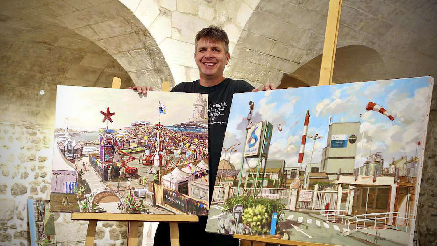 allan with two of his finished paintings