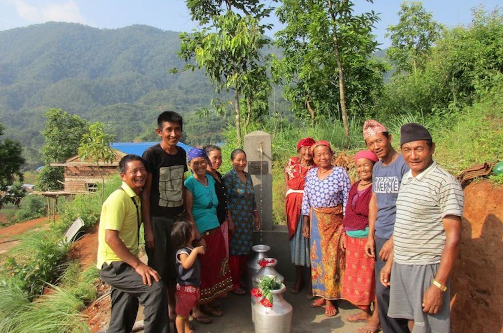 Villagers around a gravity-fed water source