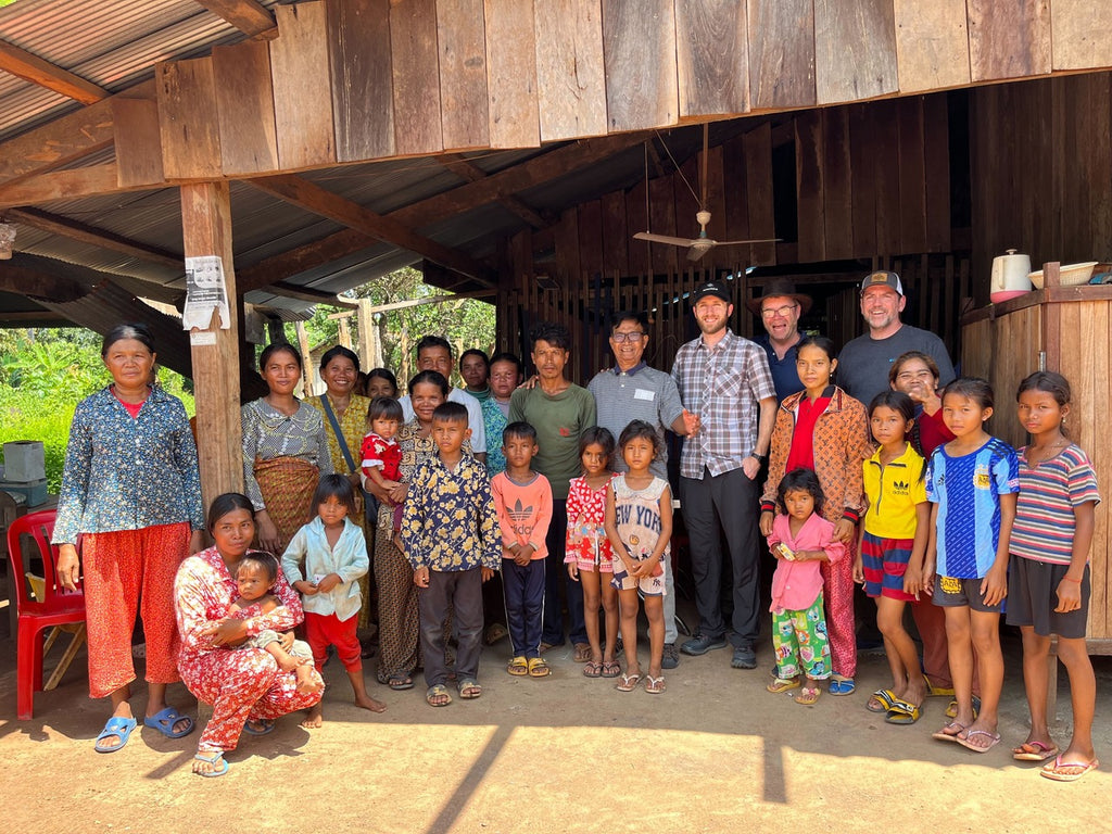 Members of a house church in Cambodia stand together with our local partners.