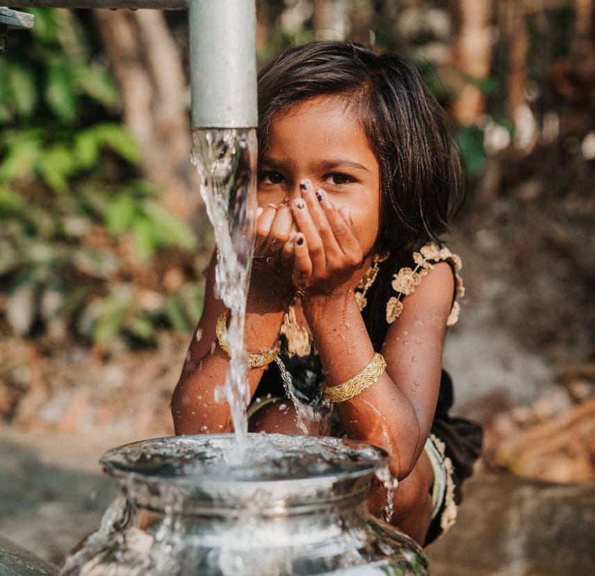 girl drinking water from neverthirst well