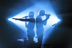 Two people singing on stage.