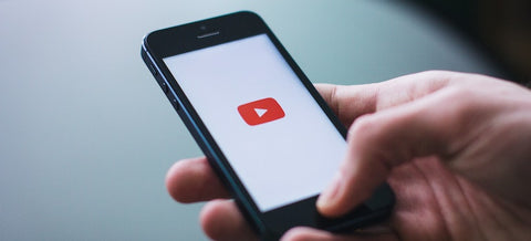 a man opening YouTube video on the phone