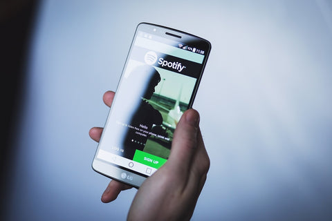 A person using Spotify on a smartphone.