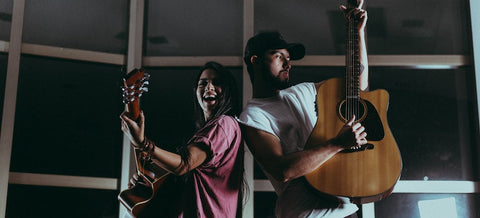 Two musicians playing guitars