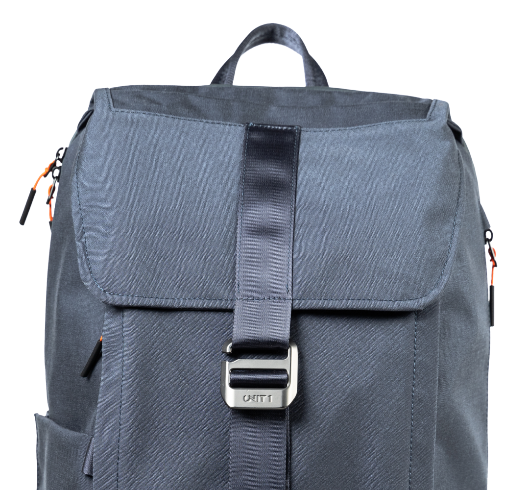 Blue backpack with a silver buckle on a black background.