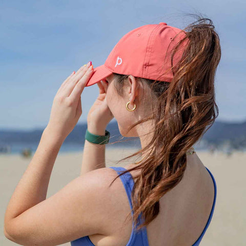 Woman with Coral Adventure Fit Ponyback ponytail hat