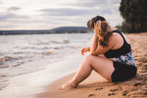 Woman on beach with black Ponyback Ponytail hat