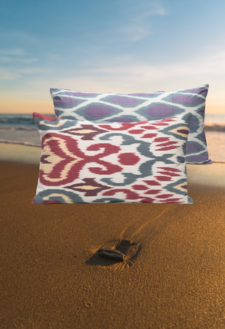 The sand and our Purple Back Citrus Blood Orange Ikat Cushion