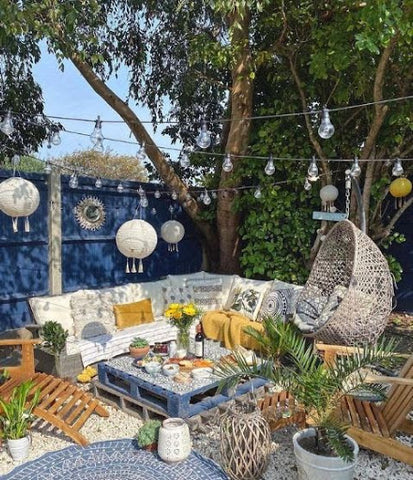 bright garden with seating and fairy lights