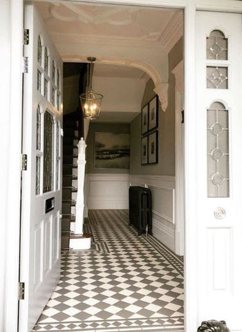 edwardian entrance to home with checked flooring 