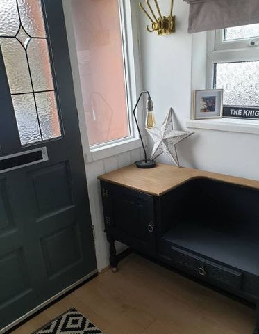 industrial table lamp on matt black shoe cupboard in hallway